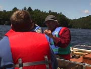 Army Corps Visit July 01 1 Bob explains how to look for Bio activity on mifoil.jpg